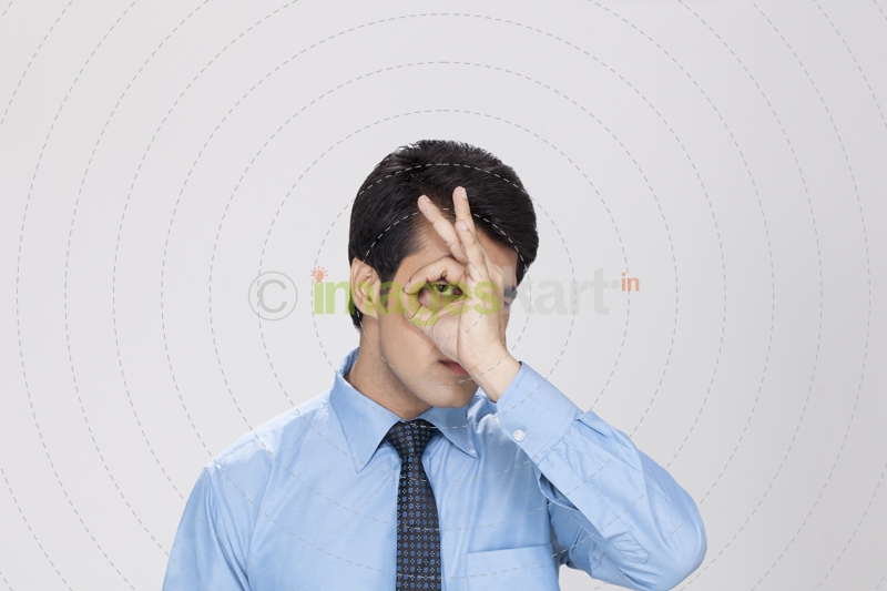 man posing while looking through hand hole 