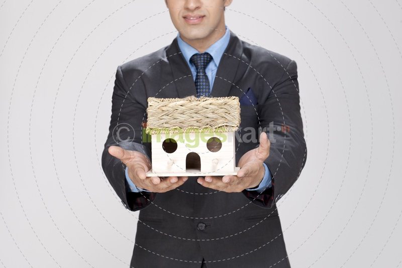 man holding home miniature