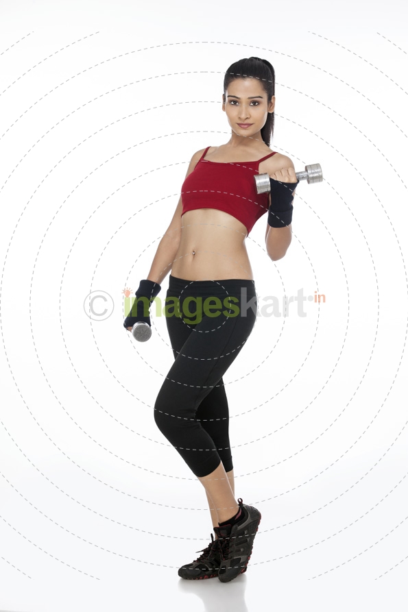 girl posing with dumbbells