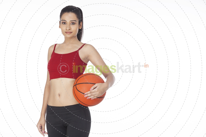 girl with basketball posing 