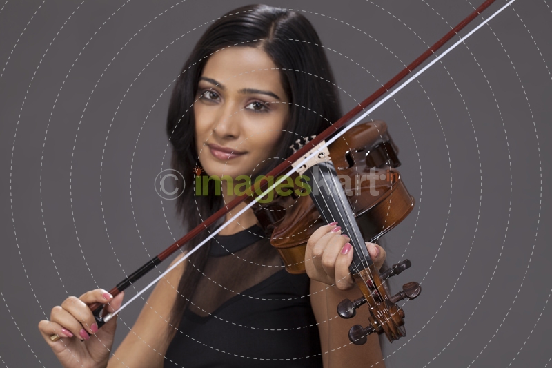 violinist playing violin and smiling