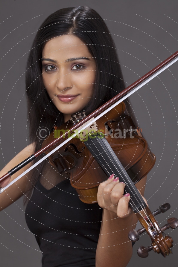girl smiling and playing violin