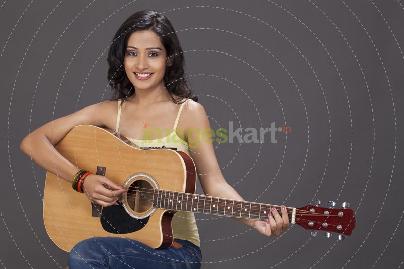 girl playing guitar and posing 