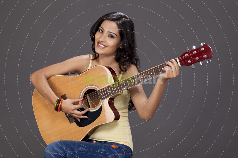girl playing guitar and posing 