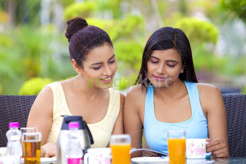 girls sitting on a breakfast table