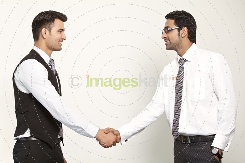 men in formals shaking hands