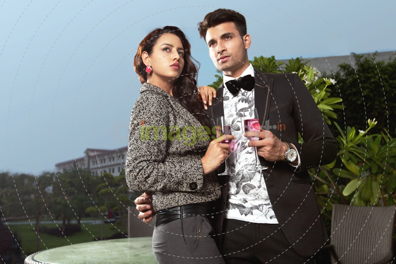 couple standing with wine glasses 