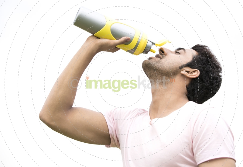 man drinking energy drink from bottle 