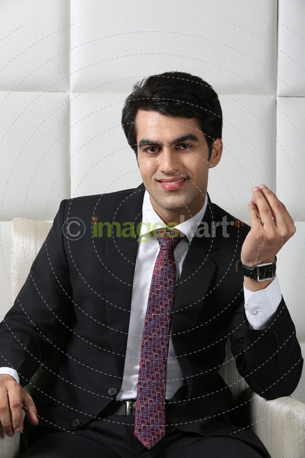man sitting and posing in formals