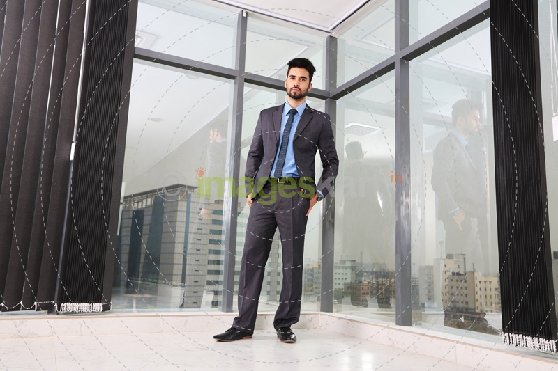 man standing with hands in pockets