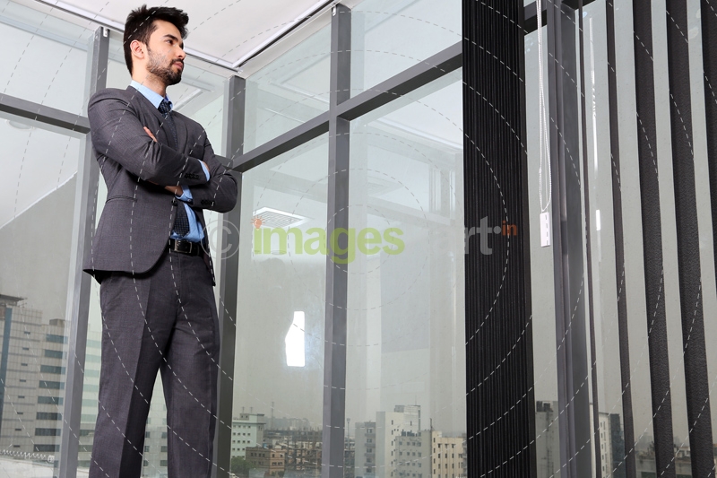 man standing at the office corridor 