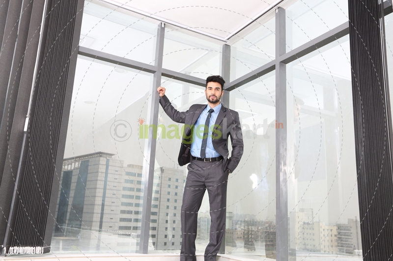 man happily posing in formal attire