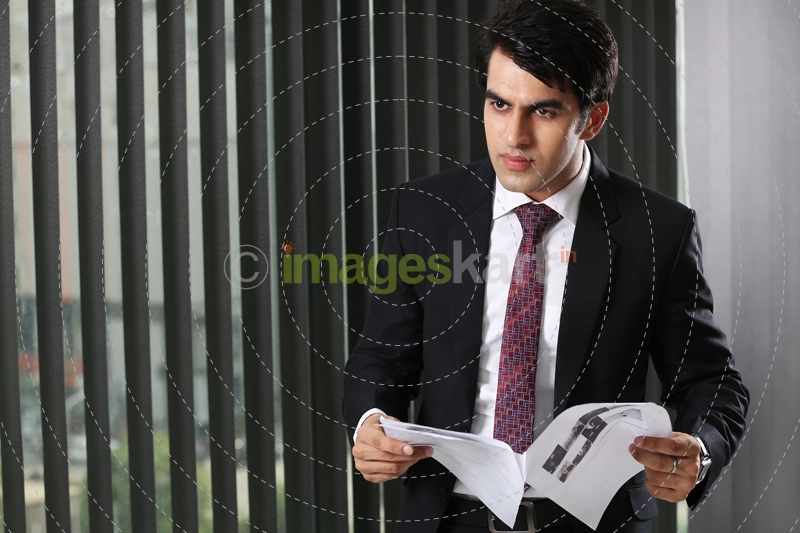 man in formals with documents in hands