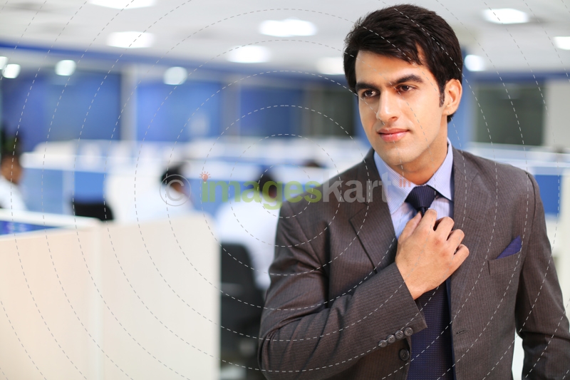 man fixing his tie