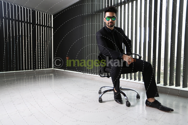 man sitting and posing in formals
