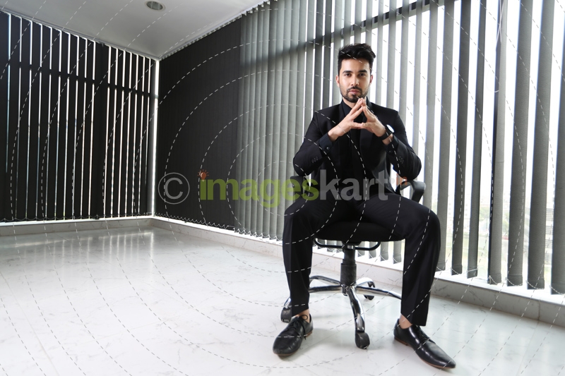 man sitting and posing in formals 