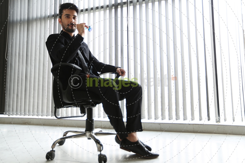 man in formals sitting on chair