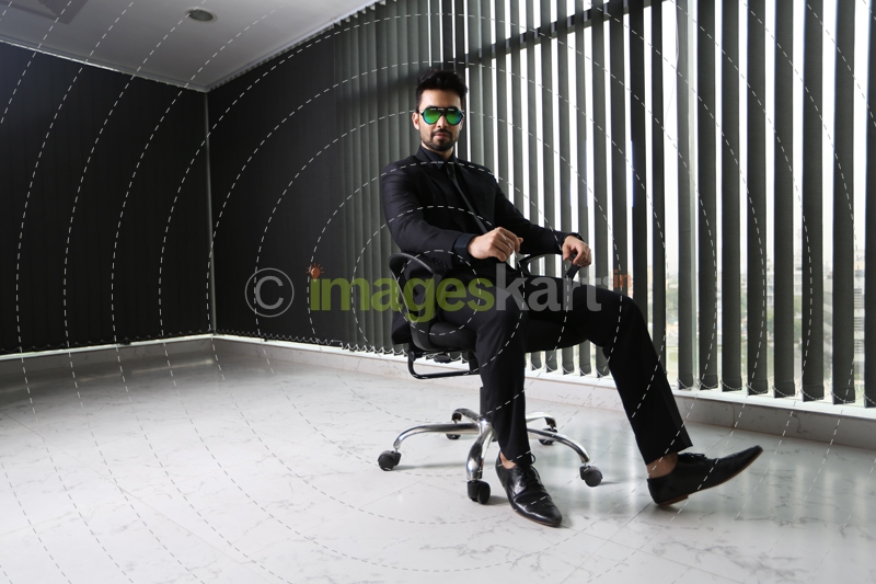 man in formals sitting and posing