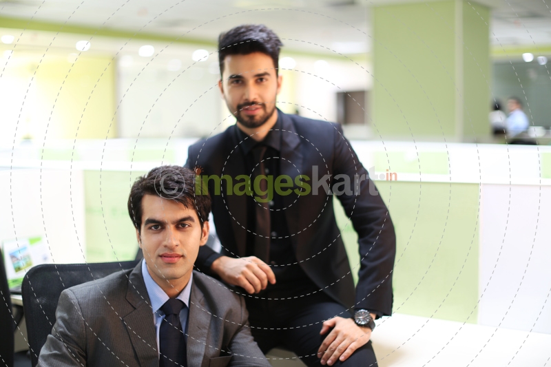 men in formal wear sitting and posing  