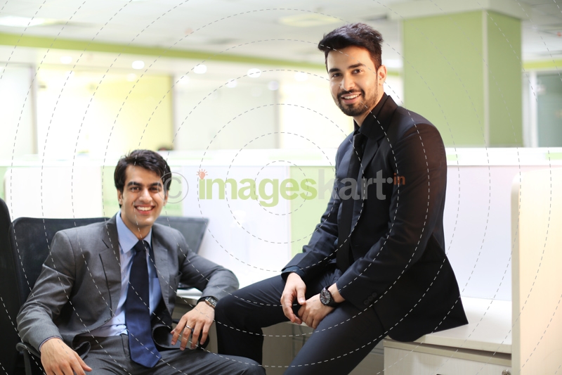 men in formal wear sitting and posing  