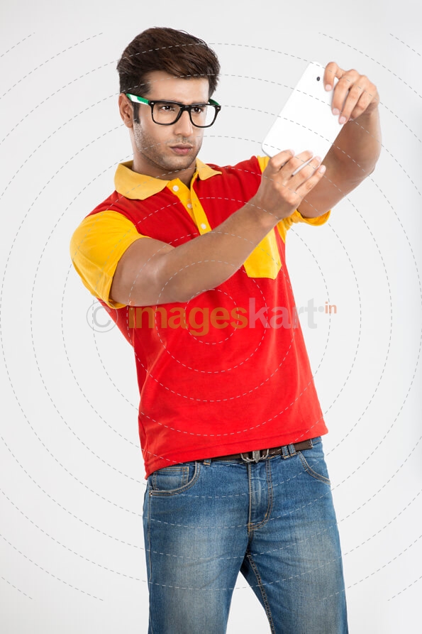 young guy playing games on tablet 