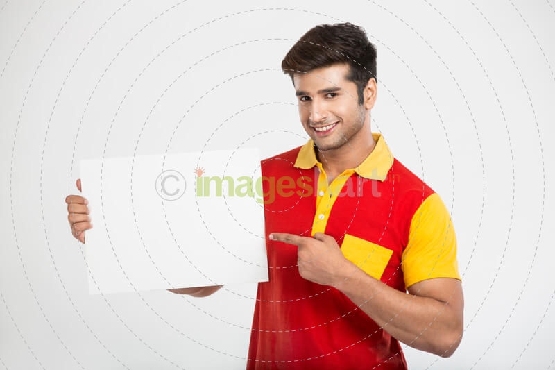 man smiling while pointing at placard