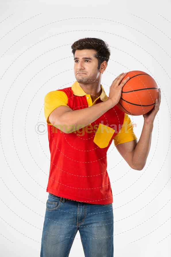 guy looking away with basketball in his hands 