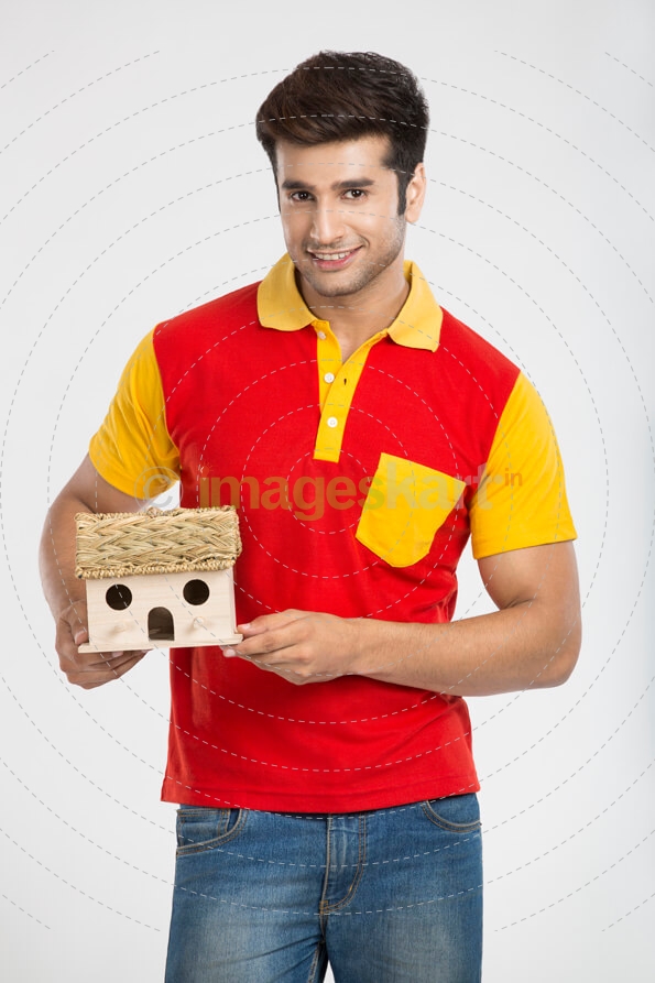 young guy posing with home miniature 