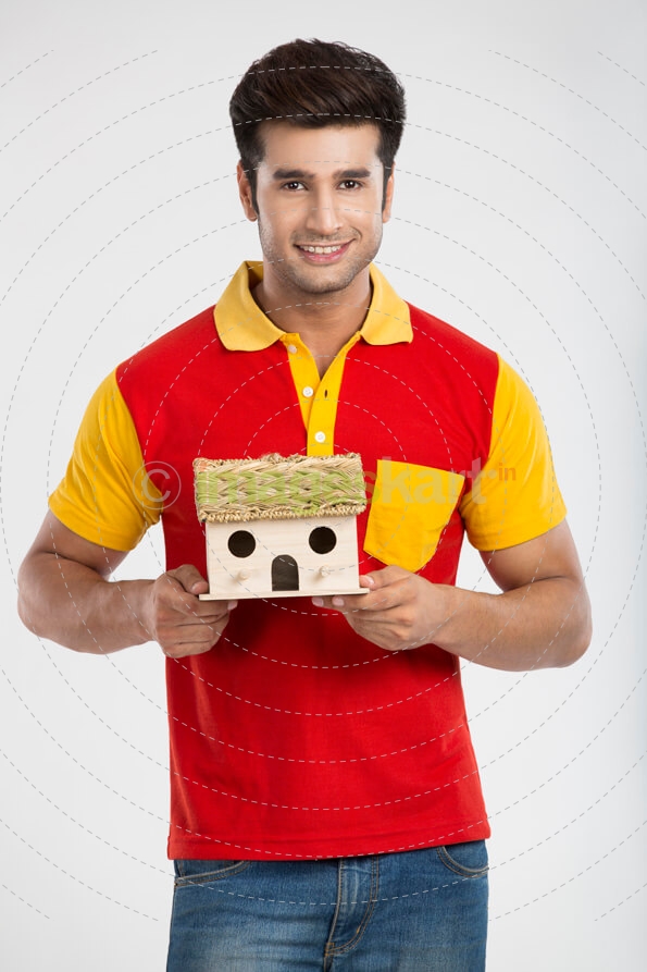 man holding home miniature with both hands 