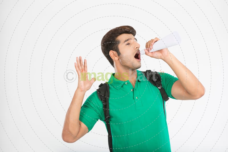 college boy using rolled sheet as loudspeaker