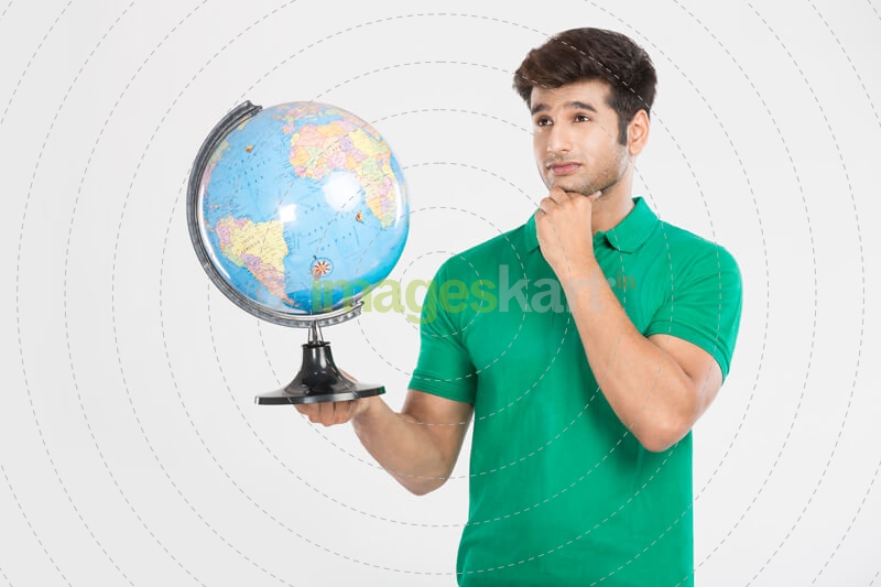 man posing with desktop globe 