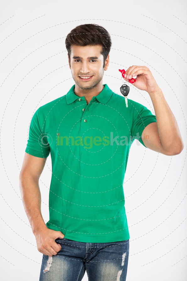 man showing car key while posing 