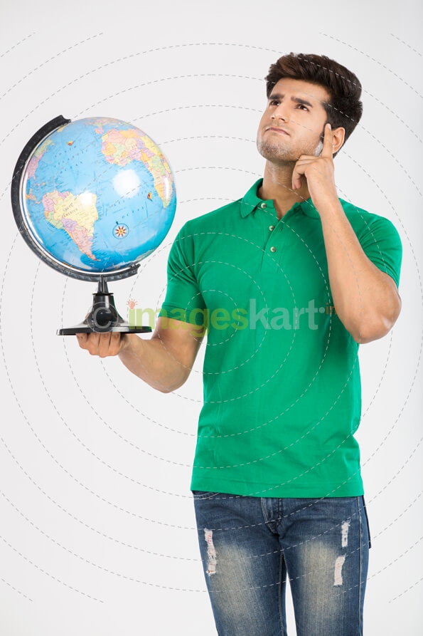man thinking while holding a desktop globe