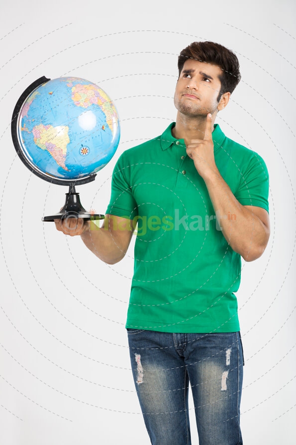 man thinking while holding a globe 
