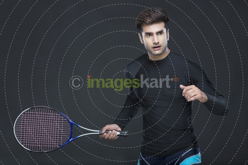 man holding tennis racket while posing for the camera 