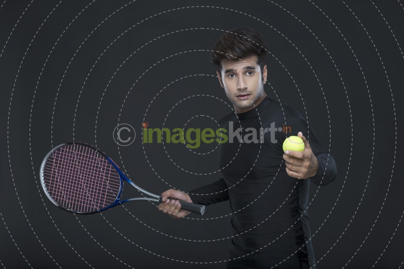 man holding tennis racket and ball