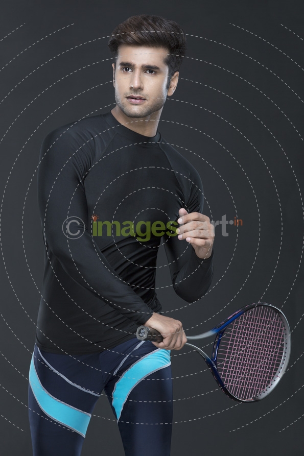 man posing while playing tennis