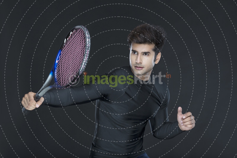 man posing as tennis player