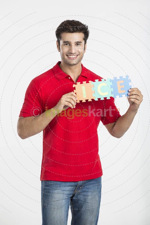 guy smiling while holding a jigsaw puzzle