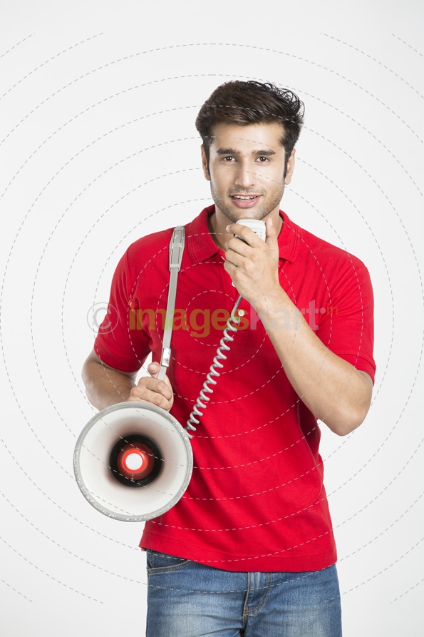 guy talking on loudspeaker while posing 