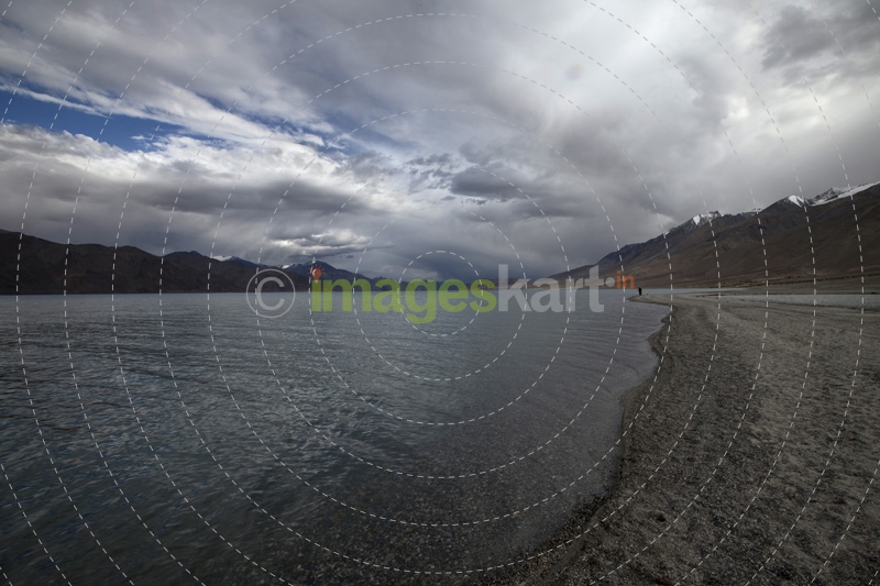 beautiful lake shore with clouds and sky in the background