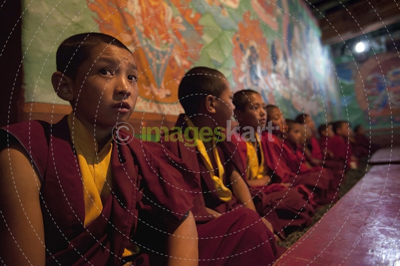 buddhist children sitting in a row in the classroom