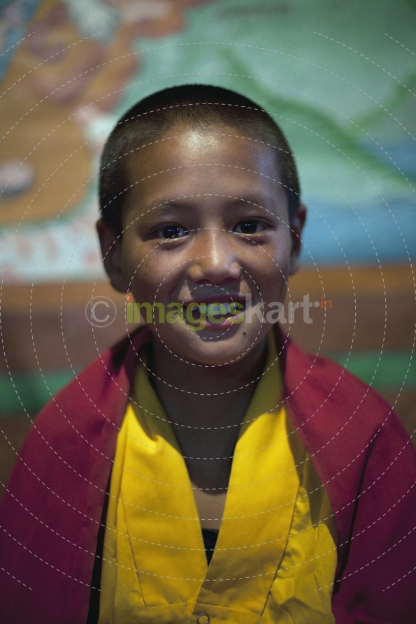 buddhist child smiling while posing for the camera  