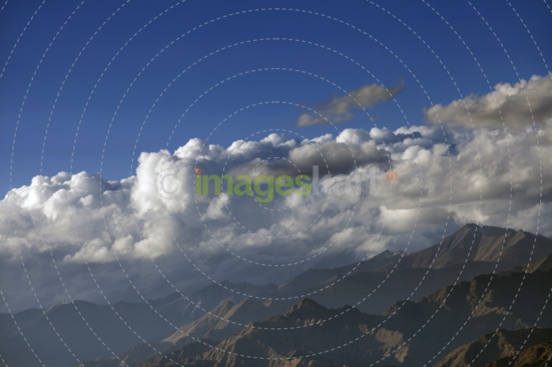 mountains with blue sky surrounded by clouds 