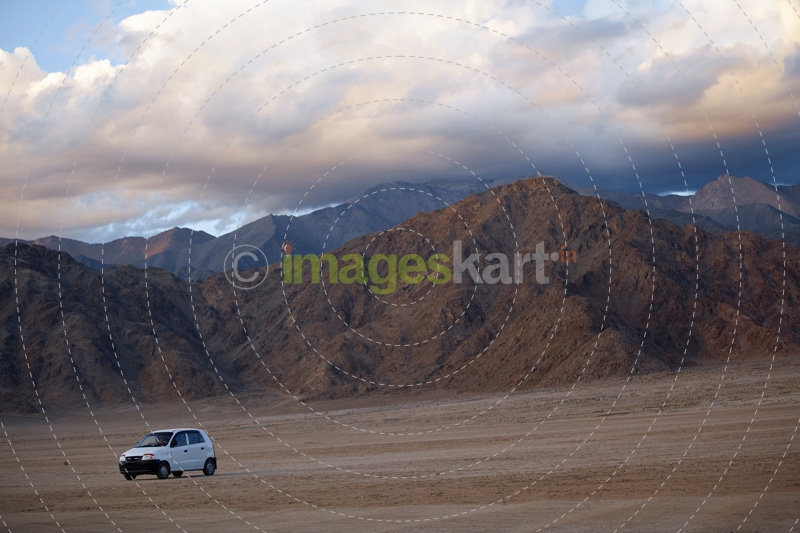 car driving through the beautiful mountain range of ladakh 
