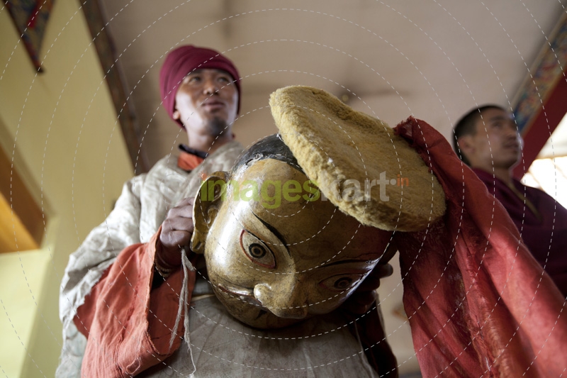 man wearing cultural costume and mask for the festival