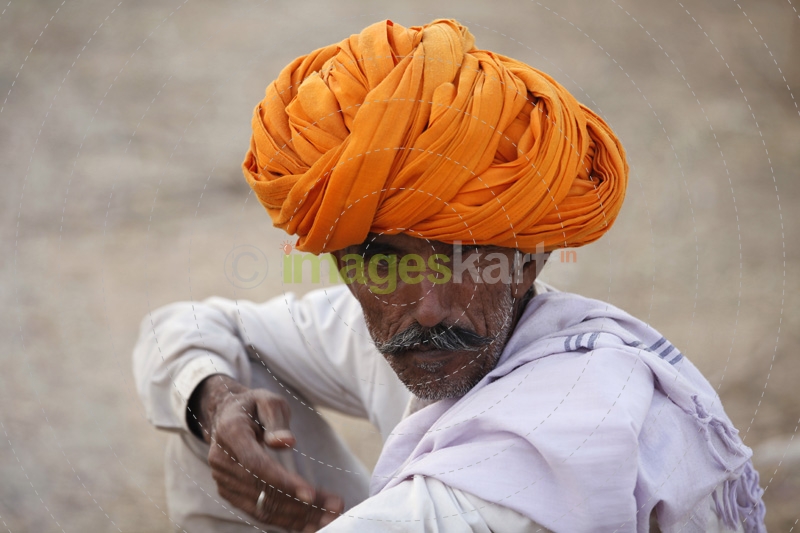 villager smoking beedi while looking at the camera 