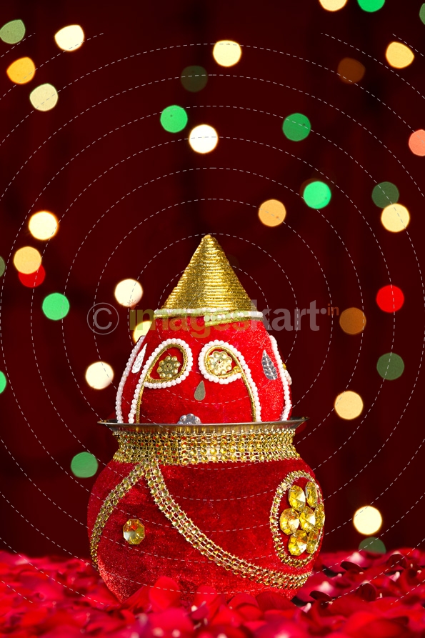 decorated kalash with lighting in background