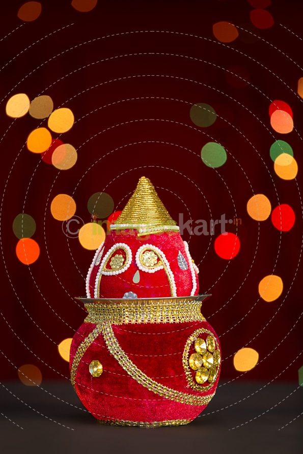 decorated kalash with lighting in background