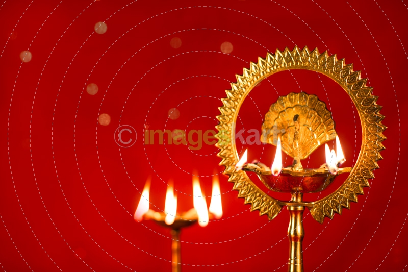diya stands against red background